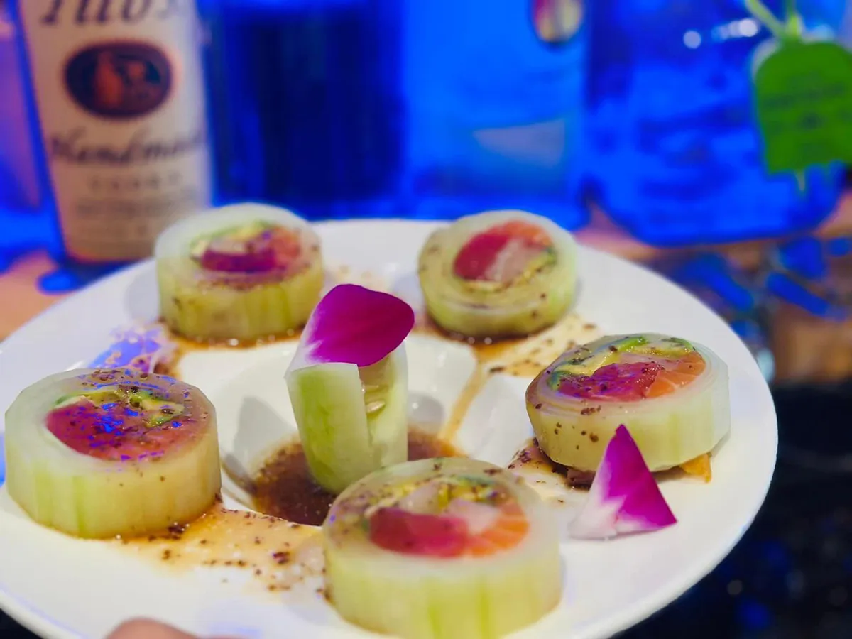 Cucumber-wrapped sashimi rolls with avocado and rose garnish at Sushi Mizu, a Japanese Restaurant in New Iberia