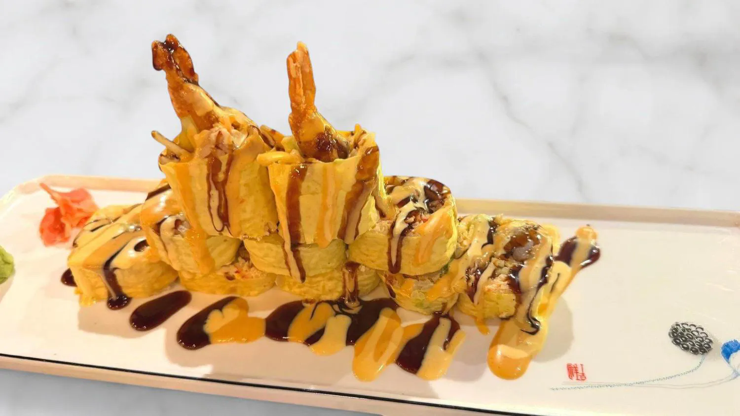 Tempura shrimp sushi roll with dual sauce drizzle at Sushi Mizu, a Japanese Restaurant in New Iberia