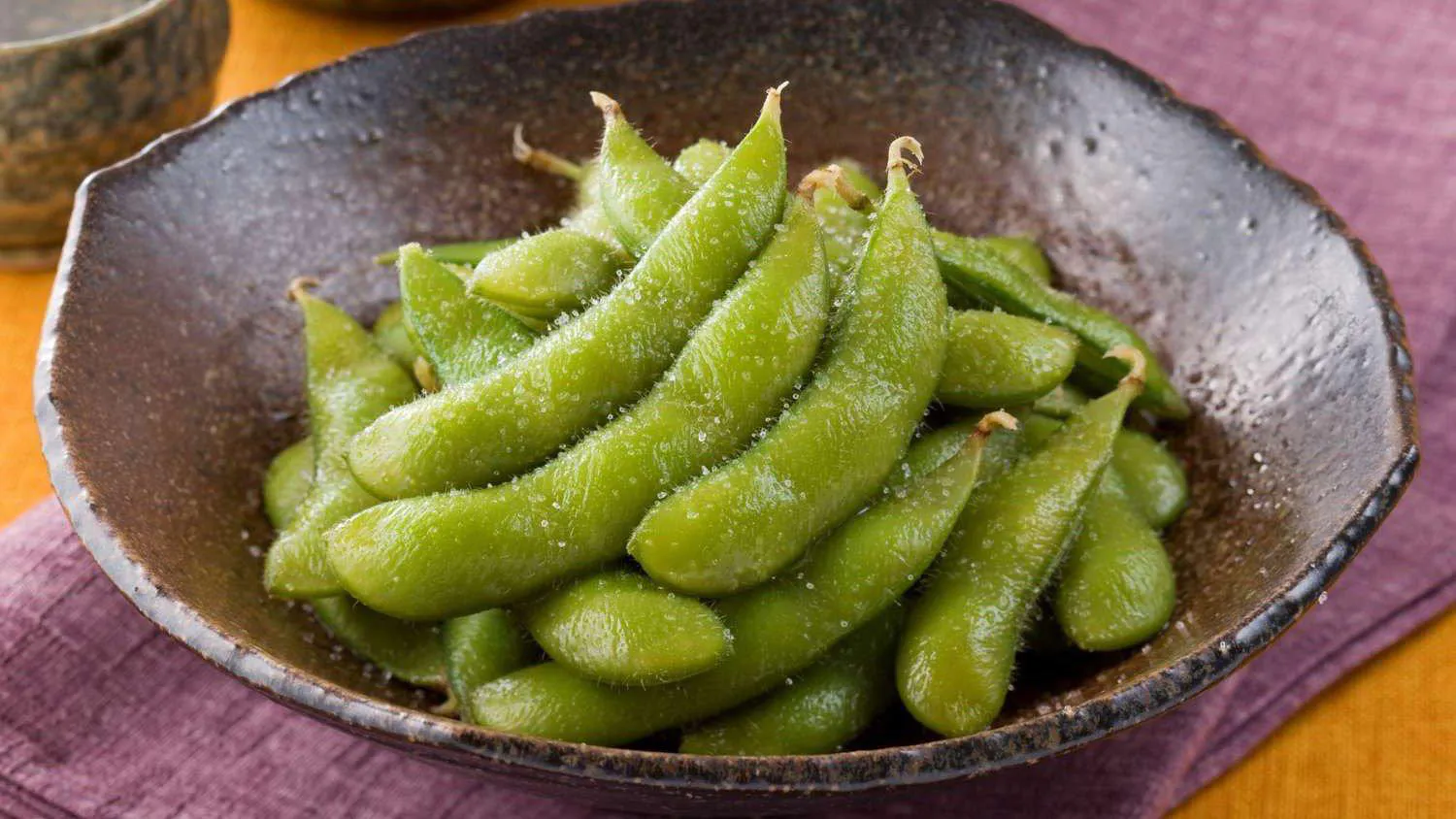 Steamed edamame with sea salt in ceramic bowl at Sushi Mizu, a Japanese Restaurant in New Iberia